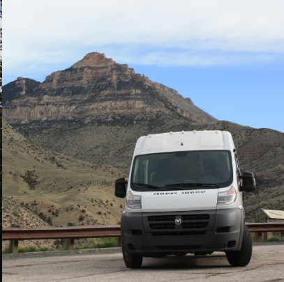 Campervan parked beneath a desert mountain